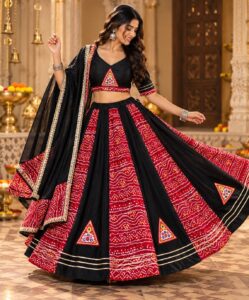 Black and red bandhani chaniya choli with mirror-work triangles for garba rental in Hyderabad